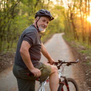 Ein Mann beim Aufsteigen auf ein Fahrrad.